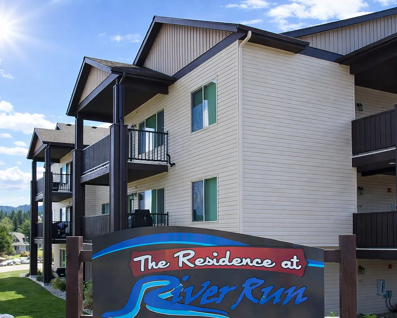 An apartment building with balconies; a sign reads 